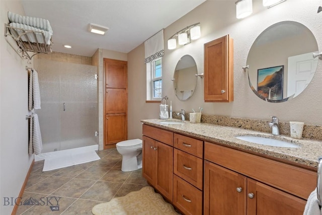 125 N Pheasant Dr, Bozeman, MT 59718 - full bath with double vanity, a shower stall, toilet, and tile patterned flooring