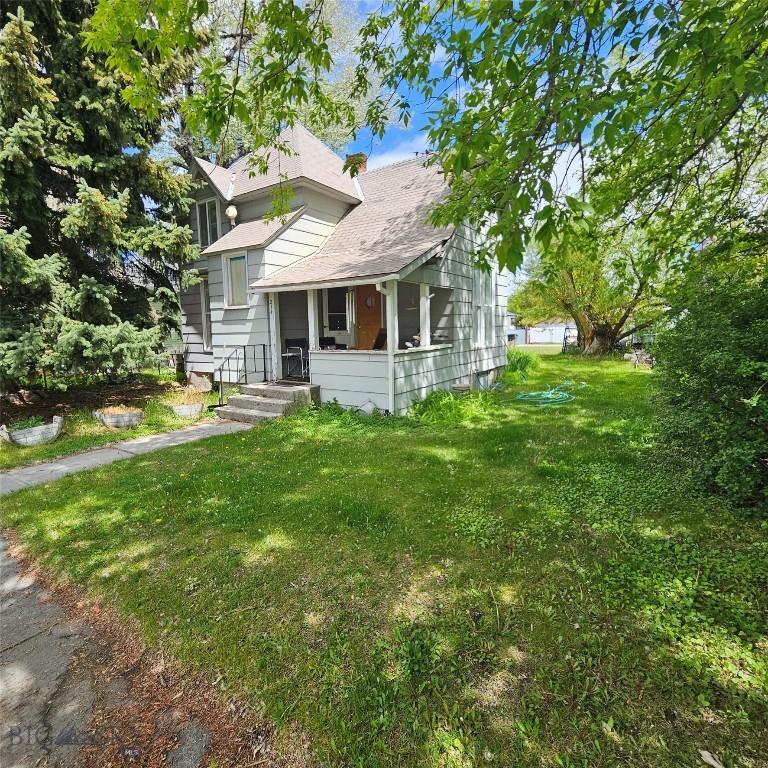 214 N Cedar St, Townsend, MT 59644 - view of front of home featuring a front lawn and a shingled roof