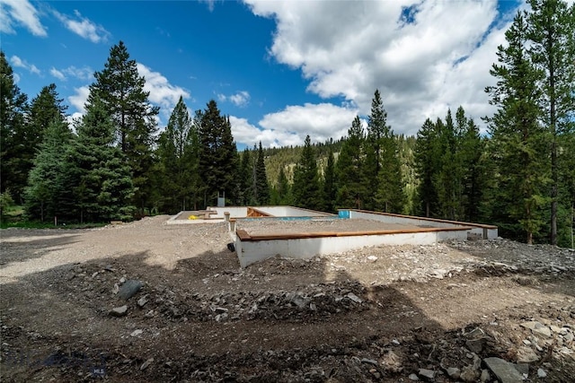 715 Colters Run Loop Lot 25, Gallatin Gateway, MT 59730 - view of yard featuring a wooded view