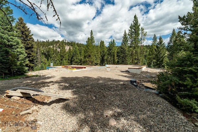 715 Colters Run Loop Lot 25, Gallatin Gateway, MT 59730 - view of yard featuring a wooded view