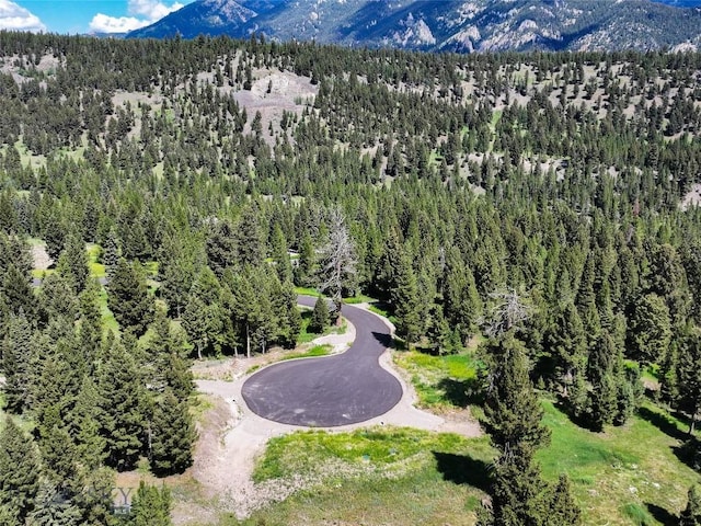 715 Colters Run Loop Lot 25, Gallatin Gateway, MT 59730 - drone / aerial view of a mountain backdrop and a heavily wooded area