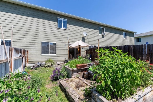 577 W Shore Dr, Belgrade, MT 59714 - rear view of house featuring a garden and a fenced backyard