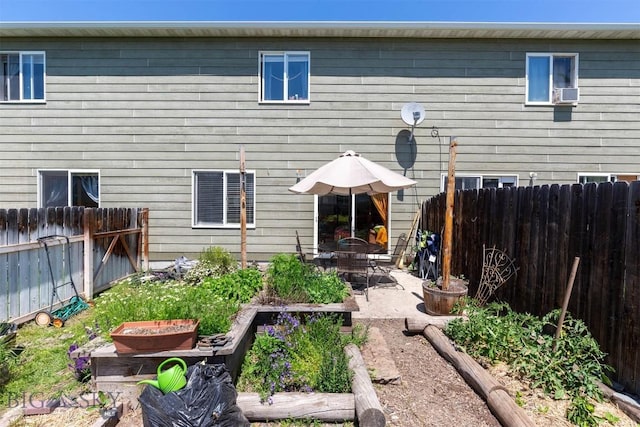 577 W Shore Dr, Belgrade, MT 59714 - back of property with a vegetable garden, a patio, and cooling unit