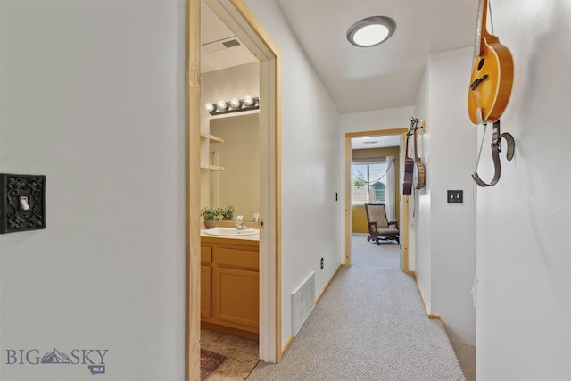 577 W Shore Dr, Belgrade, MT 59714 - hallway with a sink, light carpet, and baseboards