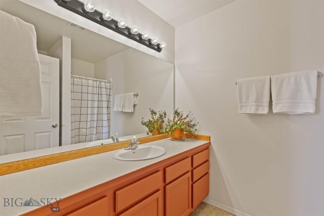 577 W Shore Dr, Belgrade, MT 59714 - bathroom with vanity, curtained shower, and tile patterned flooring