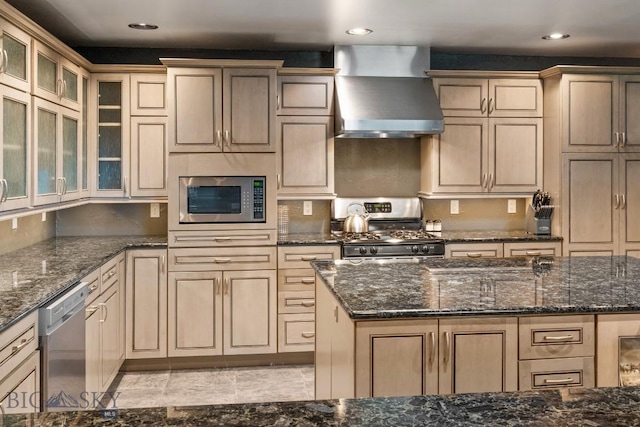 405 Swayback Rd, Mcallister, MT 59740 - kitchen with wall chimney exhaust hood, appliances with stainless steel finishes, recessed lighting, dark stone counters, and glass insert cabinets