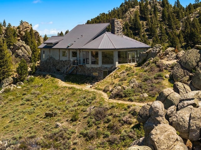 405 Swayback Rd, Mcallister, MT 59740 - rear view of property featuring metal roof, stairway, and a chimney