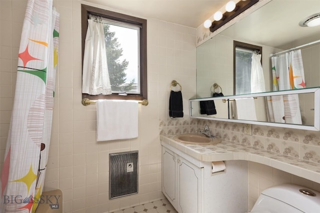 1930 Yellowtail, Big Sky, MT 59716 - full bath with toilet, tile walls, vanity, curtained shower, and decorative backsplash