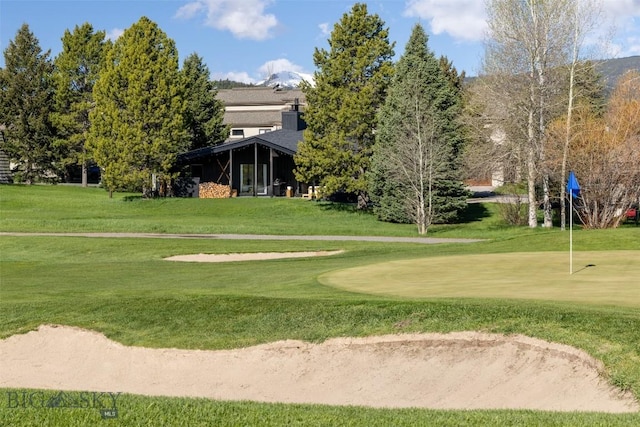 1930 Yellowtail, Big Sky, MT 59716 - view of property's community with a putting green, a lawn, and golf course view