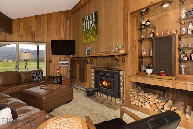 1930 Yellowtail, Big Sky, MT 59716 - living area featuring wood walls, a glass covered fireplace, a baseboard heating unit, and a bar