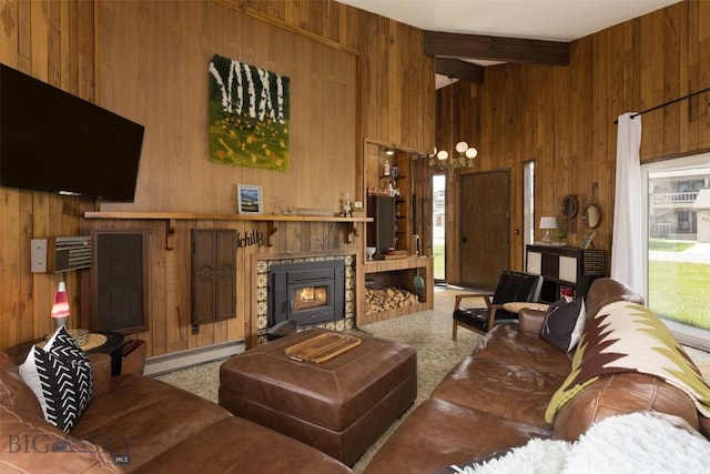 1930 Yellowtail, Big Sky, MT 59716 - living area featuring wooden walls, a baseboard heating unit, beamed ceiling, a tiled fireplace, and healthy amount of natural light