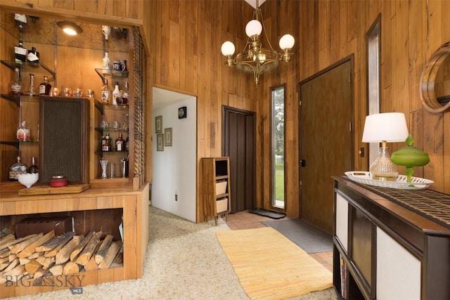 1930 Yellowtail, Big Sky, MT 59716 - carpeted entrance foyer featuring wooden walls, a chandelier, and a dry bar