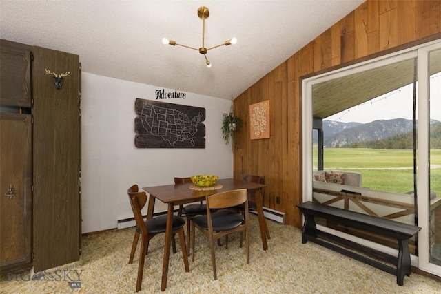 1930 Yellowtail, Big Sky, MT 59716 - dining area featuring lofted ceiling, wooden walls, a mountain view, light carpet, and a baseboard radiator