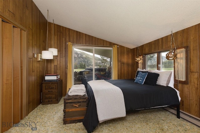 1930 Yellowtail, Big Sky, MT 59716 - bedroom with wood walls, lofted ceiling, multiple windows, access to outside, and carpet flooring