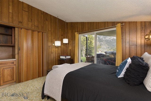 1930 Yellowtail, Big Sky, MT 59716 - carpeted bedroom with wooden walls, access to outside, and a textured ceiling