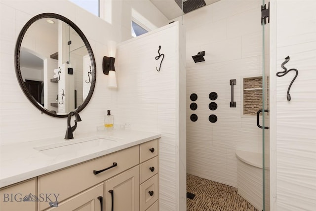 45 Cutthroat Trout, Big Sky, MT 59716 - bathroom featuring a stall shower, vanity, and tile walls