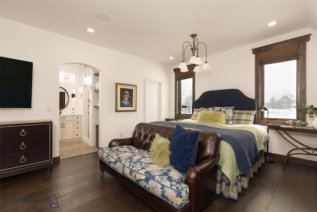 45 Cutthroat Trout, Big Sky, MT 59716 - bedroom featuring multiple windows, dark wood-style floors, arched walkways, recessed lighting, and ensuite bathroom