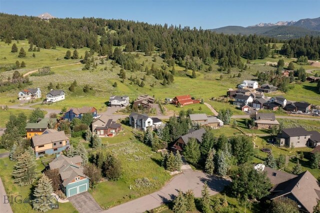 45 Cutthroat Trout, Big Sky, MT 59716 - aerial overview of property's location with a forest, nearby suburban area, and a mountain backdrop
