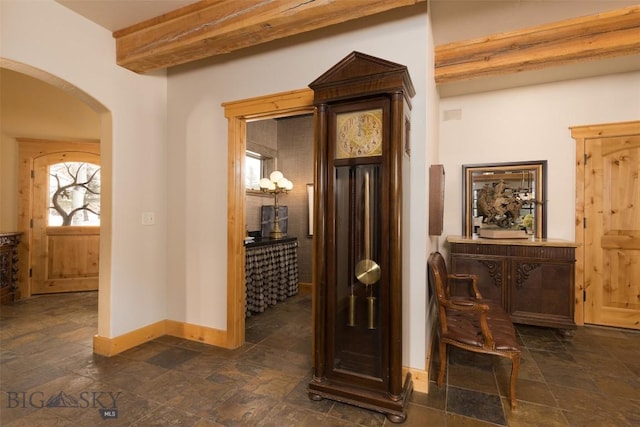 45 Cutthroat Trout, Big Sky, MT 59716 - hallway with arched walkways, baseboards, stone tile floors, and beamed ceiling