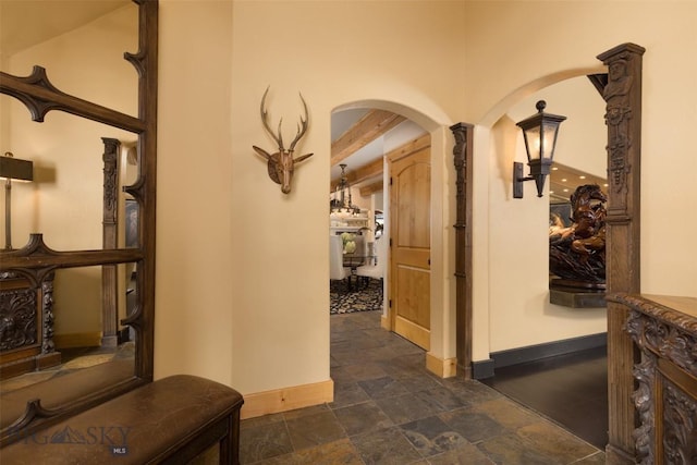 45 Cutthroat Trout, Big Sky, MT 59716 - hall featuring arched walkways, baseboards, and dark stone finish floors
