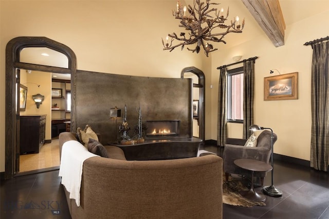 45 Cutthroat Trout, Big Sky, MT 59716 - living room featuring beamed ceiling, baseboards, and a chandelier