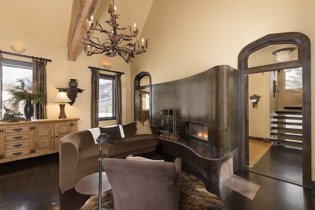 45 Cutthroat Trout, Big Sky, MT 59716 - living area with a chandelier, dark wood finished floors, a warm lit fireplace, beamed ceiling, and high vaulted ceiling