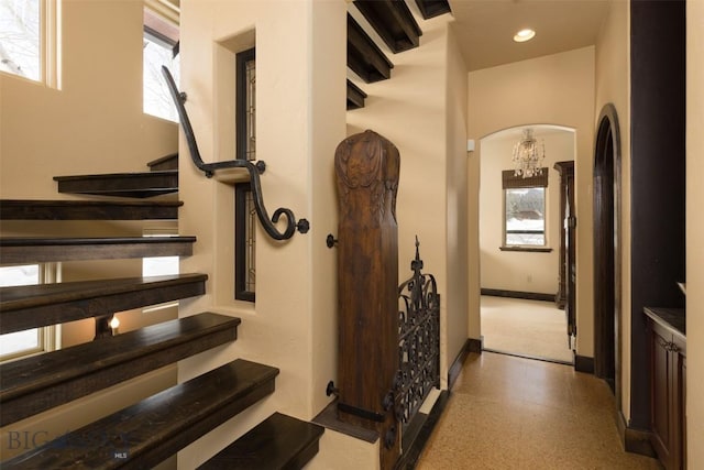45 Cutthroat Trout, Big Sky, MT 59716 - staircase with arched walkways, baseboards, speckled floor, a chandelier, and recessed lighting