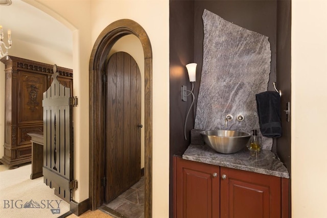 45 Cutthroat Trout, Big Sky, MT 59716 - bar featuring a sink, arched walkways, and light colored carpet