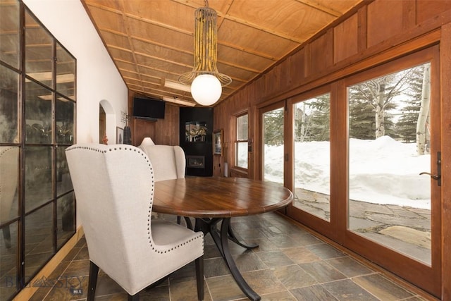 45 Cutthroat Trout, Big Sky, MT 59716 - dining room featuring plenty of natural light, wood ceiling, stone finish flooring, arched walkways, and wooden walls
