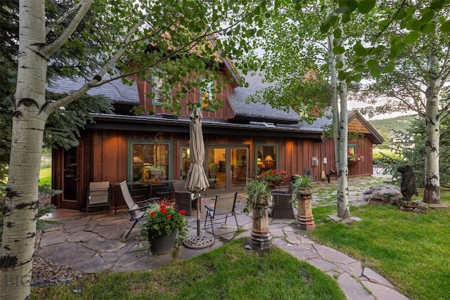 45 Cutthroat Trout, Big Sky, MT 59716 - rear view of house featuring board and batten siding, a patio, a yard, and a shingled roof