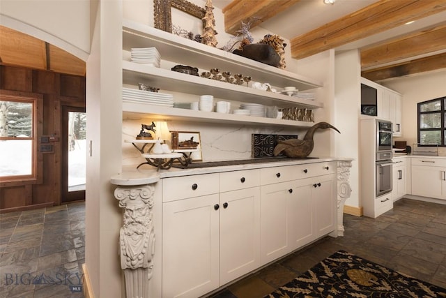 45 Cutthroat Trout, Big Sky, MT 59716 - kitchen with stone tile floors, open shelves, white cabinetry, light countertops, and arched walkways