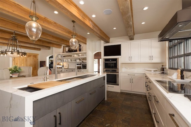 45 Cutthroat Trout, Big Sky, MT 59716 - kitchen featuring wall chimney range hood, white cabinetry, arched walkways, beamed ceiling, and dark stone finish flooring