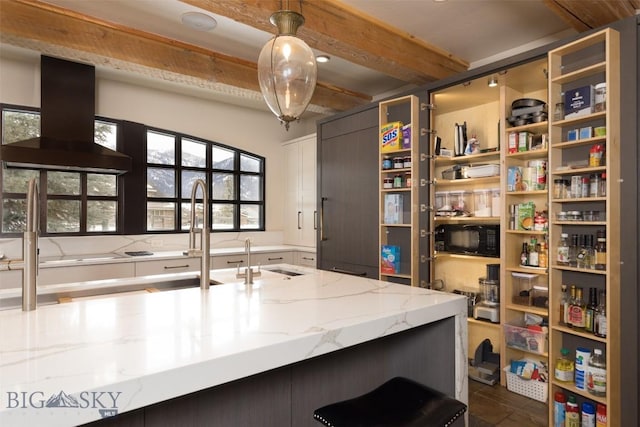45 Cutthroat Trout, Big Sky, MT 59716 - kitchen featuring black microwave, light stone countertops, hanging light fixtures, white cabinetry, and beamed ceiling