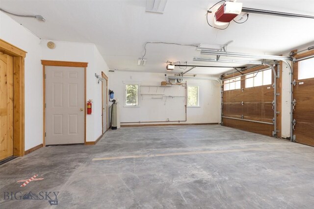 45 Cutthroat Trout, Big Sky, MT 59716 - garage with a garage door opener and baseboards