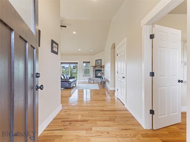 50 Pattee Trl, Bozeman, MT 59718 - entrance foyer featuring light wood-style floors, high vaulted ceiling, a stone fireplace, and baseboards