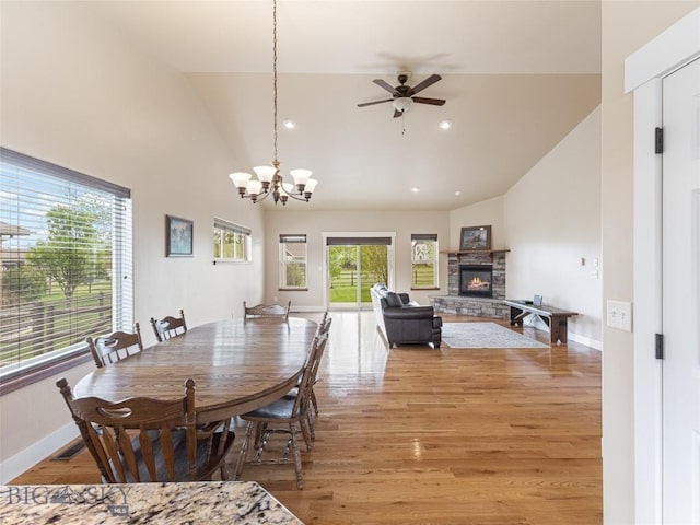 50 Pattee Trl, Bozeman, MT 59718 - dining area with a ceiling fan, light wood-style floors, baseboards, a stone fireplace, and a chandelier