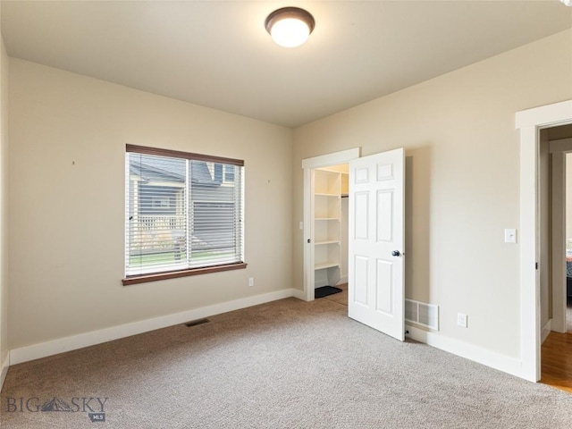 50 Pattee Trl, Bozeman, MT 59718 - unfurnished bedroom featuring carpet flooring, baseboards, a walk in closet, and a closet