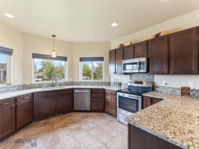 50 Pattee Trl, Bozeman, MT 59718 - kitchen featuring appliances with stainless steel finishes, a sink, plenty of natural light, dark brown cabinets, and recessed lighting