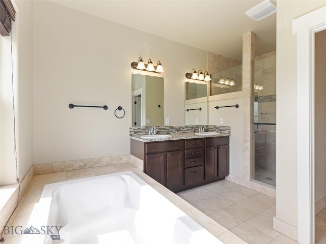 50 Pattee Trl, Bozeman, MT 59718 - full bathroom featuring a garden tub, a shower stall, double vanity, and tile patterned floors