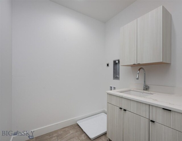 1745 Windward Ave Unit A, Bozeman, MT 59718 - laundry room featuring cabinet space, baseboards, washer hookup, light wood finished floors, and electric dryer hookup