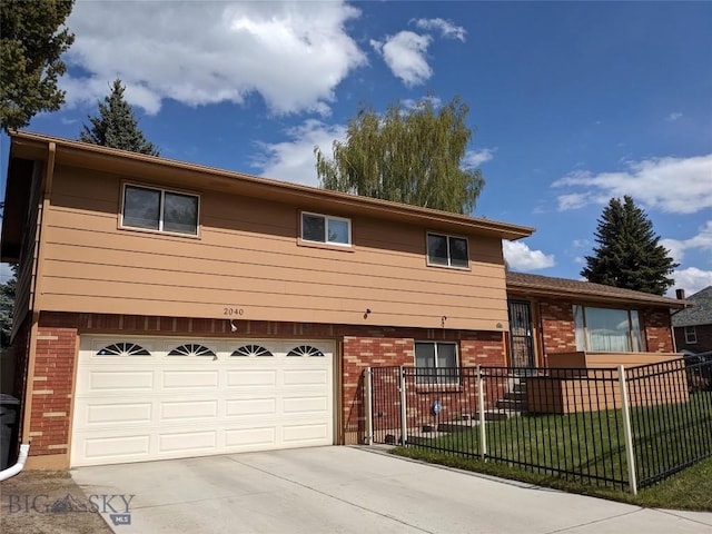 2040 Adams, Butte, MT 59701 - split level home with brick siding, an attached garage, and concrete driveway