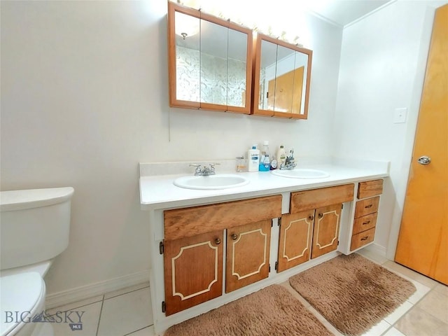 2040 Adams, Butte, MT 59701 - bathroom featuring toilet, tile patterned floors, double vanity, and baseboards