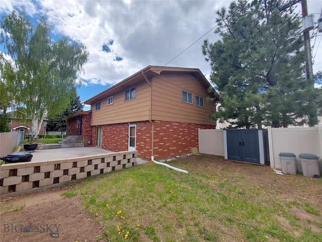 2040 Adams, Butte, MT 59701 - view of side of home featuring brick siding and a gate