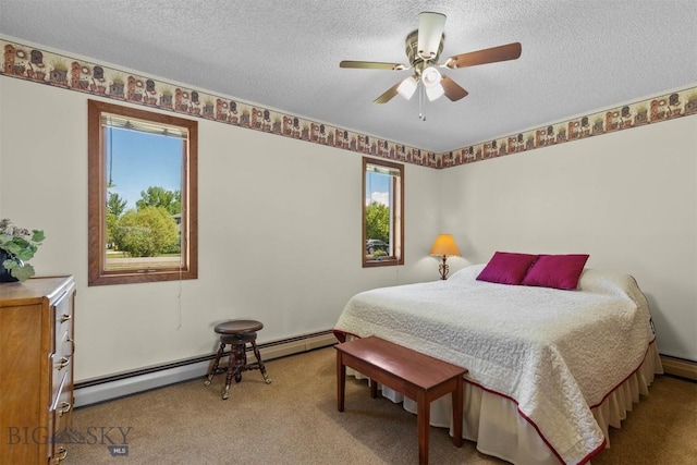 1385 Baldy Mountain Ln, Belgrade, MT 59714 - carpeted bedroom featuring multiple windows, a textured ceiling, a baseboard radiator, and a ceiling fan