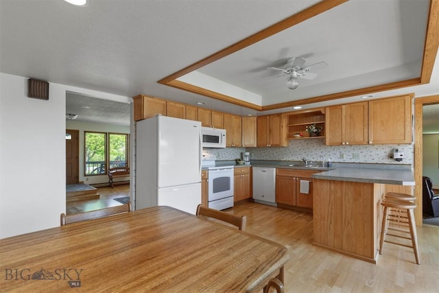 1385 Baldy Mountain Ln, Belgrade, MT 59714 - kitchen with white appliances, a tray ceiling, open shelves, light wood-style floors, and ceiling fan