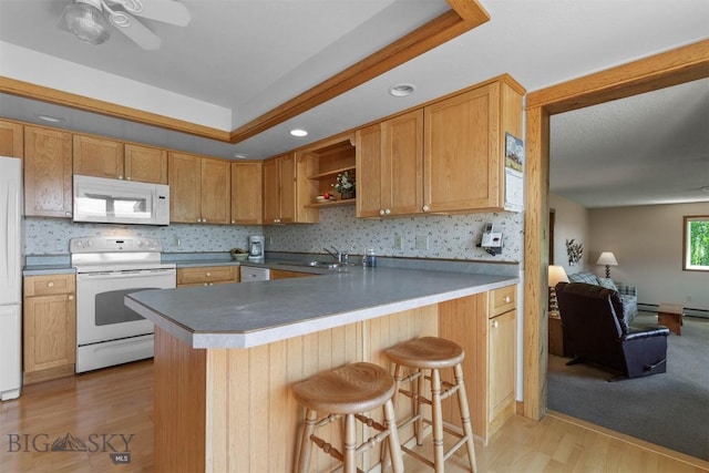 1385 Baldy Mountain Ln, Belgrade, MT 59714 - kitchen with white appliances, a sink, open shelves, a kitchen bar, and light wood finished floors