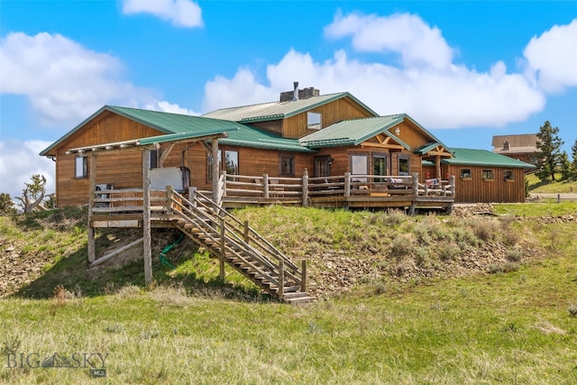 125 Rocky Mountain Mdws, Bozeman, MT 59715 - back of property with stairway, metal roof, and a deck