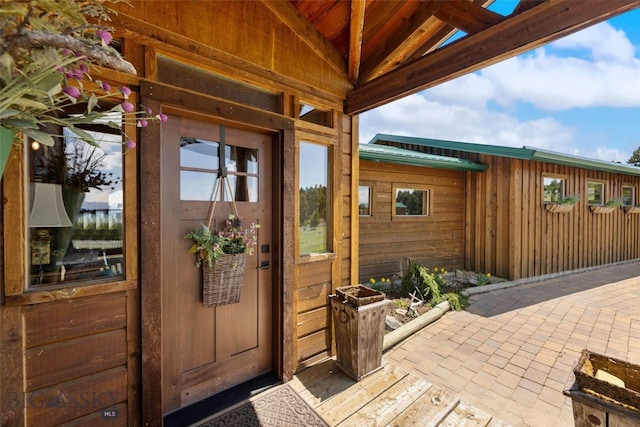 125 Rocky Mountain Mdws, Bozeman, MT 59715 - view of exterior entry with metal roof and a patio area