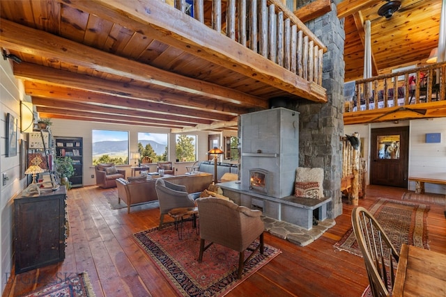 125 Rocky Mountain Mdws, Bozeman, MT 59715 - living room with hardwood / wood-style floors, a tile fireplace, wooden ceiling with exposed beams, and a mountain view