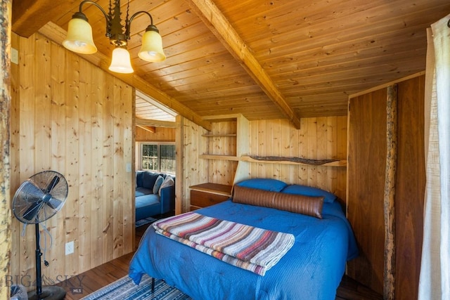 125 Rocky Mountain Mdws, Bozeman, MT 59715 - bedroom with wooden walls, wood ceiling with exposed beams, wood finished floors, and a chandelier